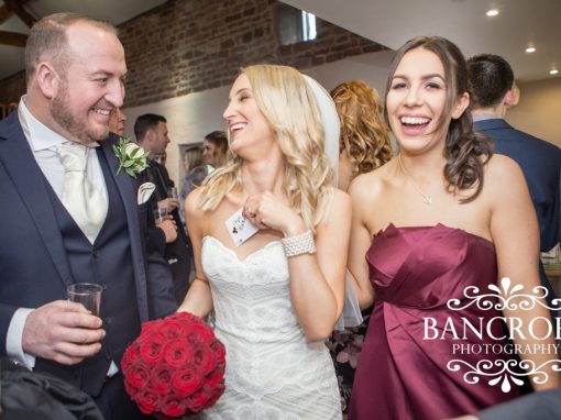 Bride laughing with card found in her hand at wedding
